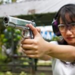 how should you hold a handgun for maximum accuracy?